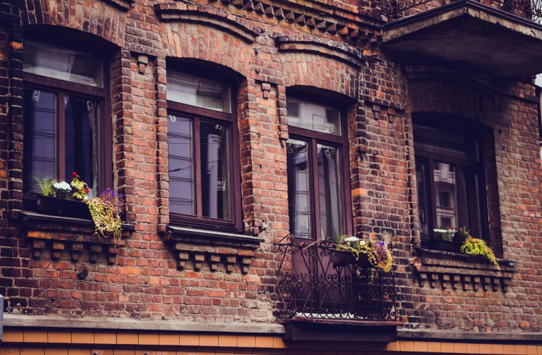 a couple of windows sitting on the side of a building, by Adam Marczyński, pexels contest winner, art nouveau, old brick walls, background image