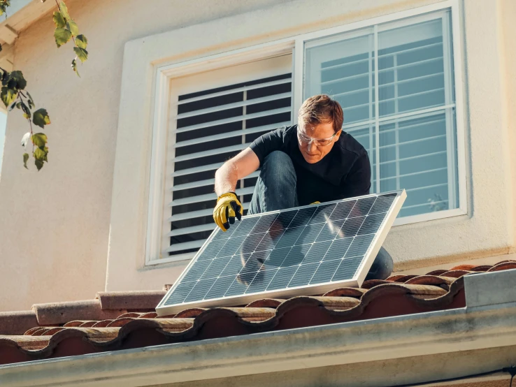 a man installing a solar panel on the roof of a house, a stock photo, by Xul Solar, shutterstock, renaissance, 15081959 21121991 01012000 4k, analog photo, sci-fi themed, sydney hanson