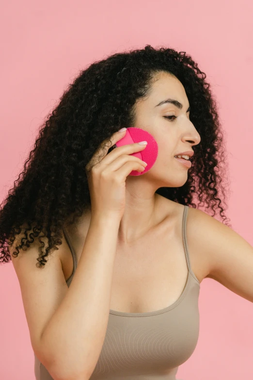 a woman brushing her hair with a pink brush, trending on pexels, renaissance, girl making a phone call, imaan hammam, smooth fuschia skin, athletic muscle tone