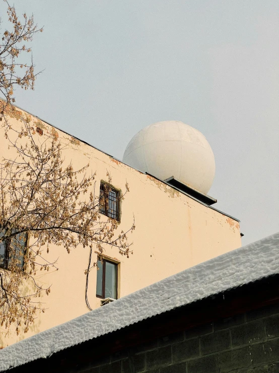 a building with a dome on top of it, inspired by Elsa Bleda, rain sensor, snow camouflage, khreschatyk, seen from outside