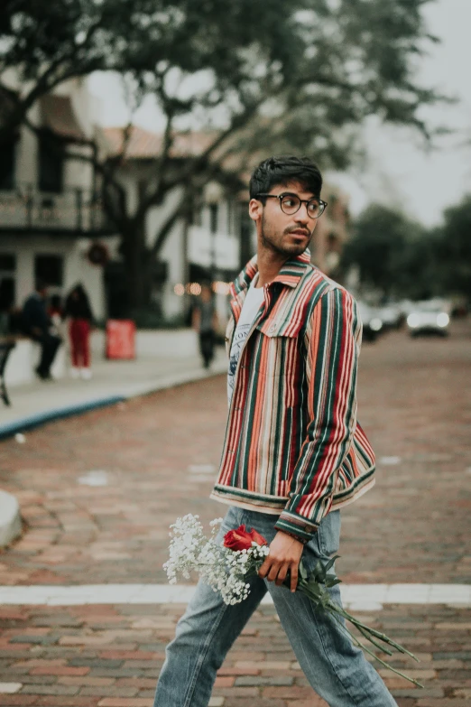 a man walking down the street with a bouquet of flowers, by Byron Galvez, pexels contest winner, striped shirt, jewish young man with glasses, indian, wearing a fancy jacket