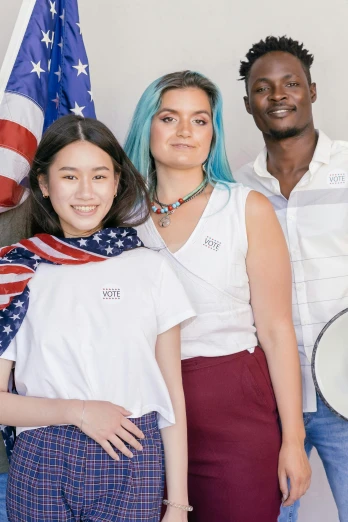 a group of people standing next to each other, a colorized photo, inspired by Itō Seiu, trending on unsplash, renaissance, american flag in background, fashion model features, on a white table, official store photo