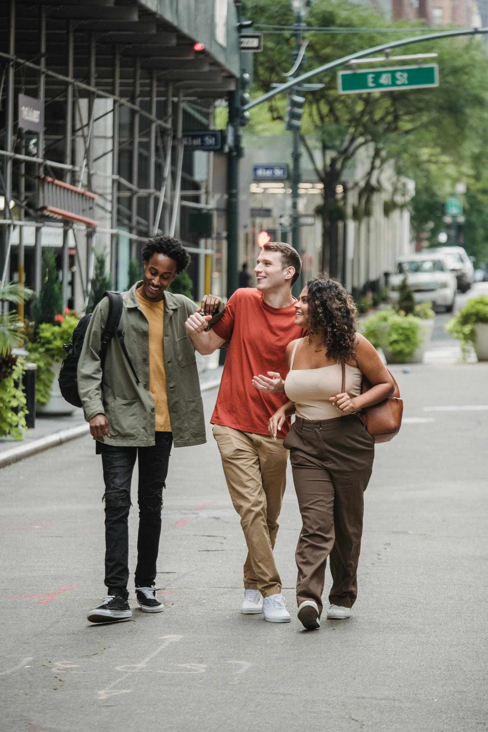 a group of people walking down a street, in new york, friends, promotional image, college