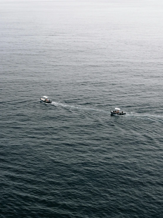 a couple of boats that are in the water, pexels contest winner, private press, in the ocean, 2 5 6 x 2 5 6 pixels, slight overcast, shot from 5 0 feet distance