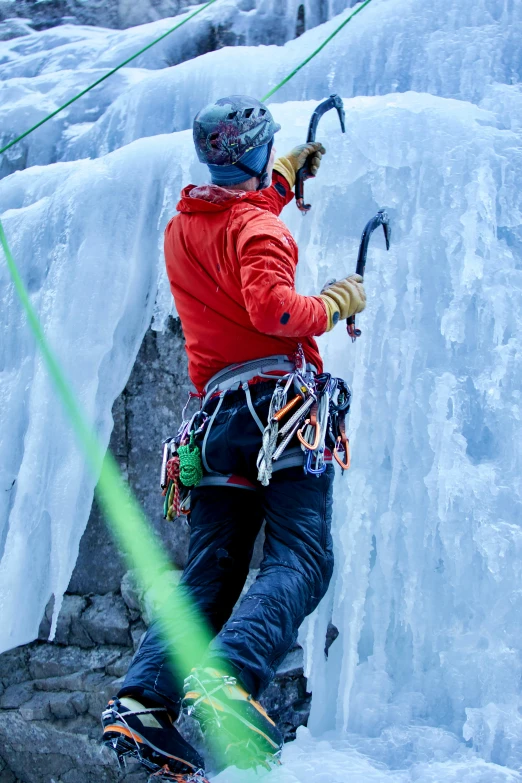 a man standing on top of a snow covered mountain, belaying, frozen and covered in ice, striking colour, a green