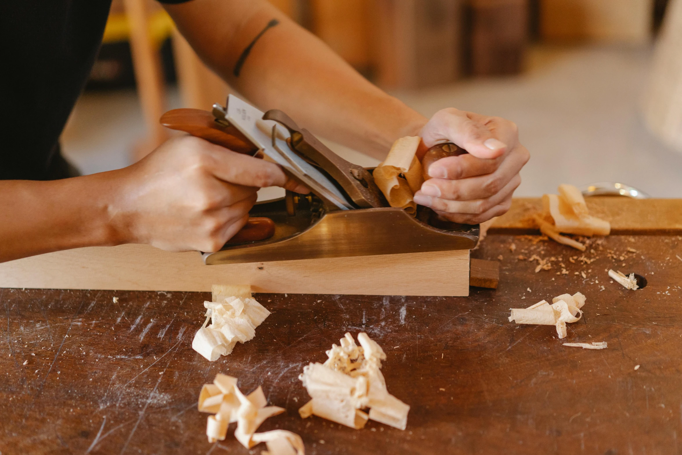 a person using a plane to cut a piece of wood, by Jessie Algie, pexels contest winner, arts and crafts movement, french provincial furniture, frontal shot, schools, wooden bowl