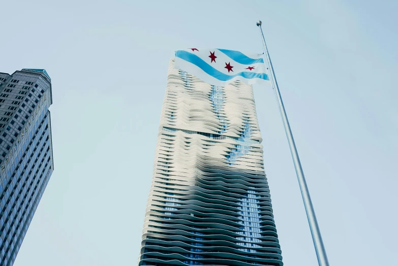 a tall building with a flag flying in front of it, inspired by Zha Shibiao, unsplash contest winner, hurufiyya, chicago, shoreline, album cover, ignant