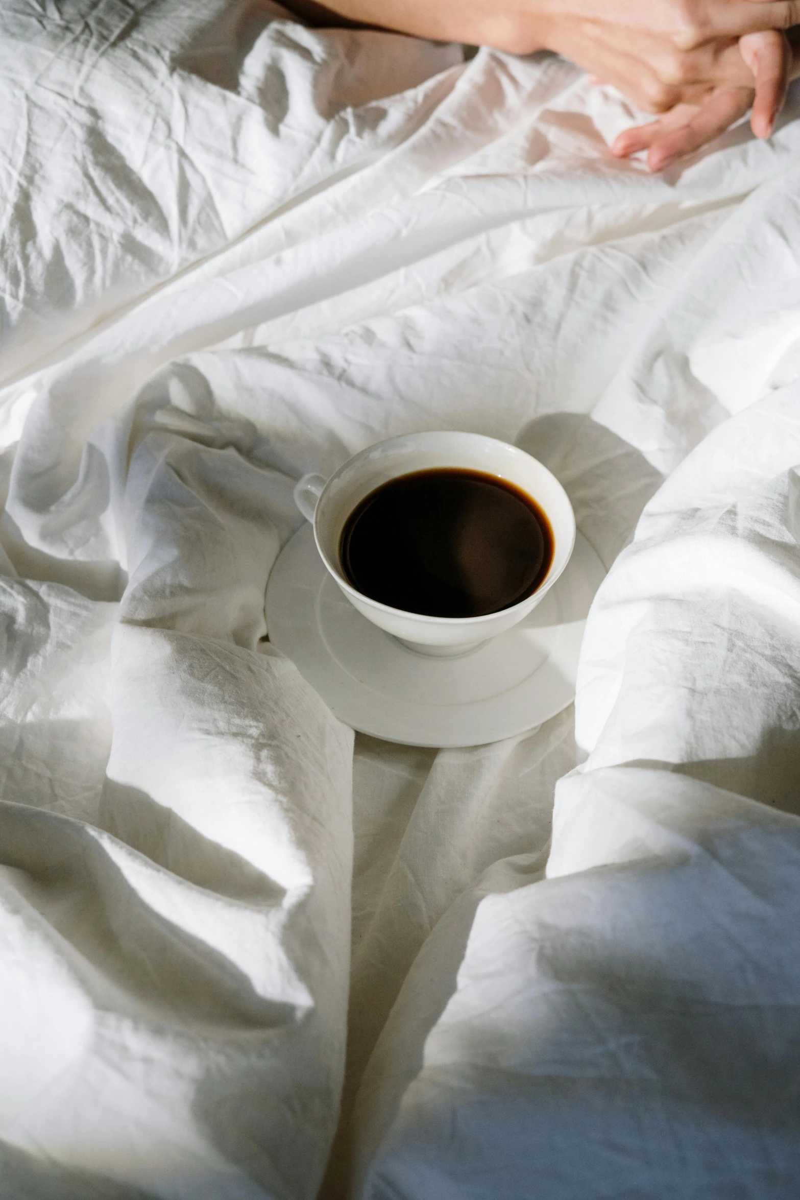 a person laying in bed with a cup of coffee, by Alison Geissler, made of lab tissue, white cloth in wind shining, trending photo, soup