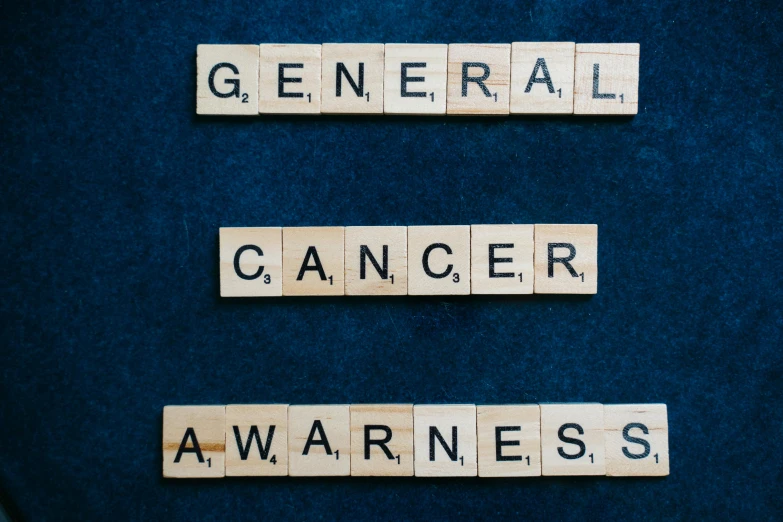 the word cancer spelled in scrabbles on a blue background, an album cover, by Emma Andijewska, pexels contest winner, cereal, on black background, avatar image, a wooden