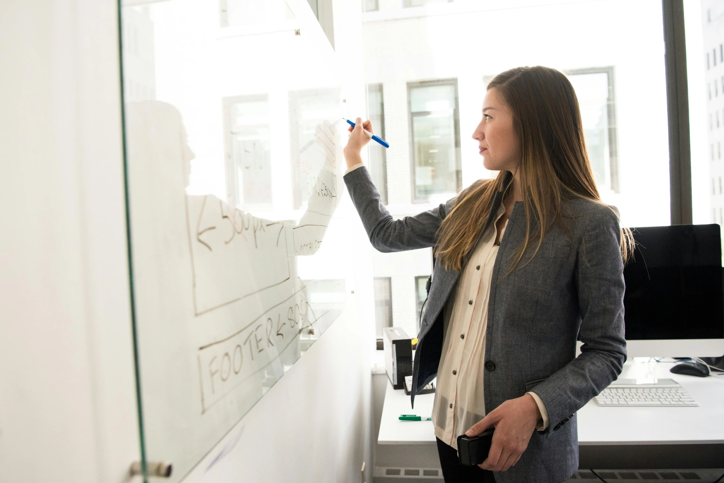 a woman writing on a white board in an office, pexels contest winner, walking to the right, profile image, girl standing, very clear picture