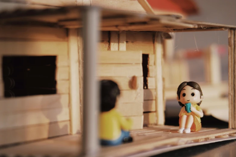 a doll that is sitting in front of a doll house, inspired by Nara Yoshitomo, pexels contest winner, mingei, tiny villagers, shack close up, architect, film still from an cartoon