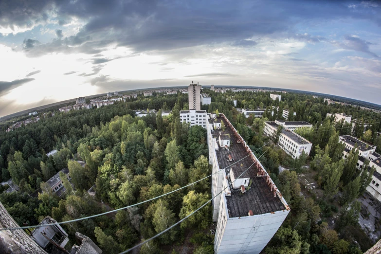 a very tall building sitting in the middle of a forest, a portrait, by Adam Marczyński, unsplash, bauhaus, nuclear aftermath, panoramic view, high angle uhd 8 k, 000 — википедия