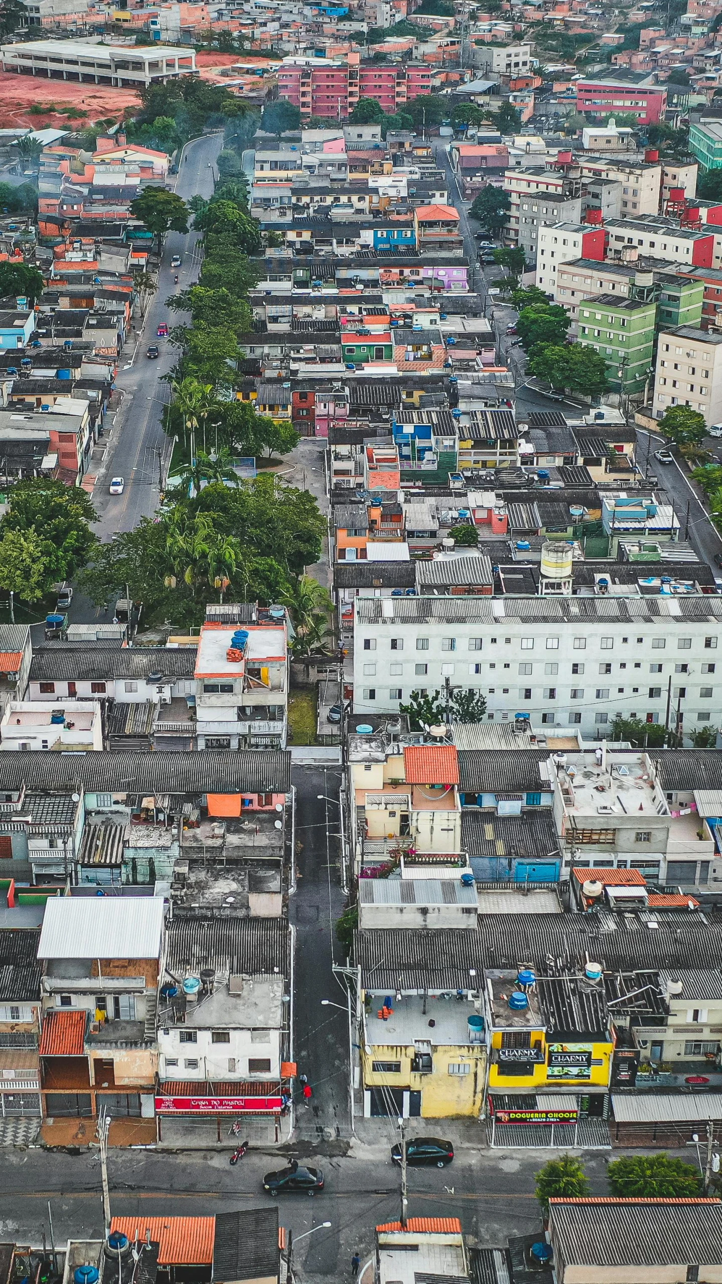 an aerial view of a city with lots of buildings, by Felipe Seade, happening, tiled roofs, single building, urban street, stacked houses