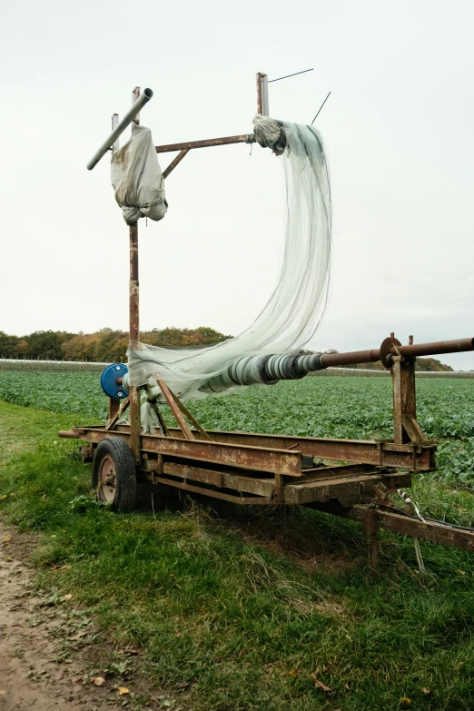 a truck driving down a dirt road next to a field, a silk screen, by Yasushi Sugiyama, renaissance, with pipes attached to it, 2006 photograph, fisherman, lettuce