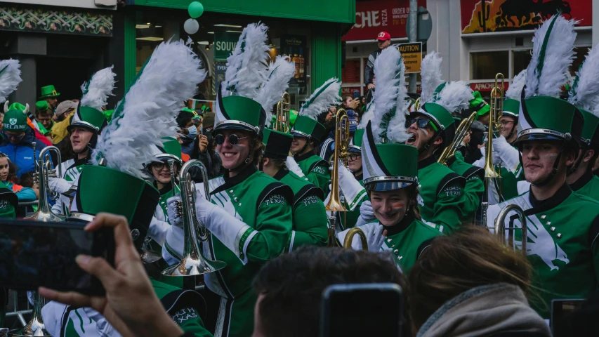 a group of people that are standing in the street, pexels contest winner, happening, parade setting, irish, band promo, green and white