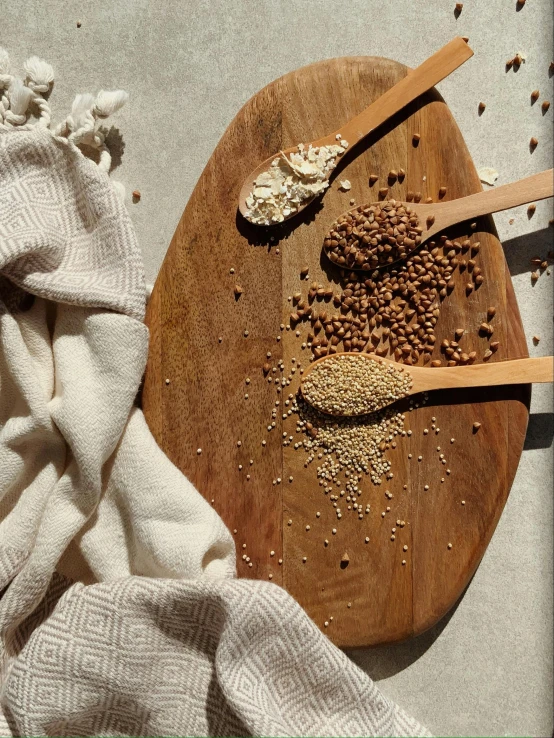 a white towel sitting on top of a wooden cutting board, a picture, thumbnail, luscious with sesame seeds, spoon placed, detailed product image