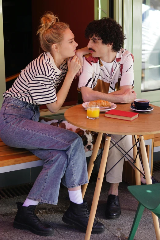 a couple of people that are sitting at a table, wearing stripe shirt, french kiss, federation clothing, baggy jeans