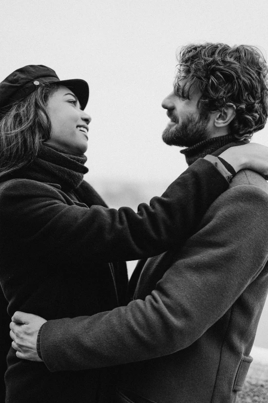 a man and woman standing next to each other, a black and white photo, by Lucia Peka, pexels, happy cozy feelings, breton cap, jesus hugging a woman, attractive man