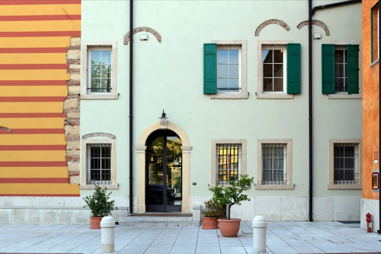 a white fire hydrant sitting in front of a building, an album cover, by Lubin Baugin, neoclassicism, windows and walls :5, inter dimensional villa, green and yellow, minimalissimo