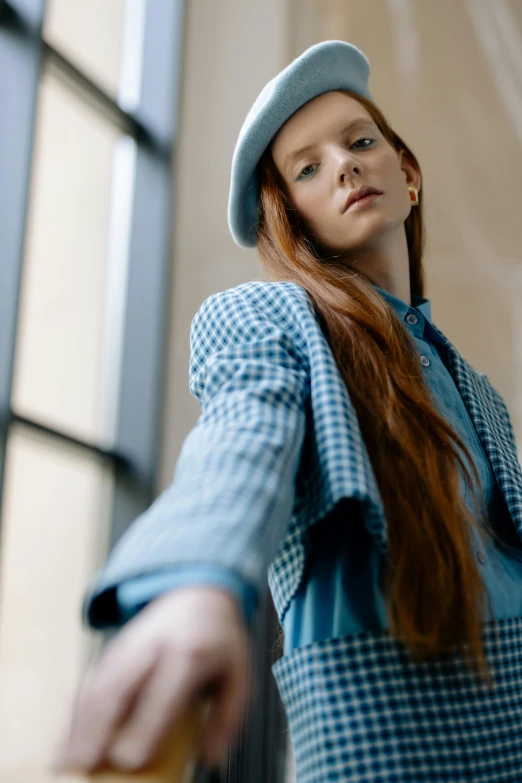 a woman with long red hair wearing a blue dress and hat, trending on pexels, wearing a plaid shirt, delicate androgynous prince, professional modeling, she is wearing streetwear