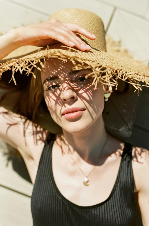 a woman with a straw hat on her head, trending on pexels, sophia lillis, sun overhead, sydney sweeney, jewelry