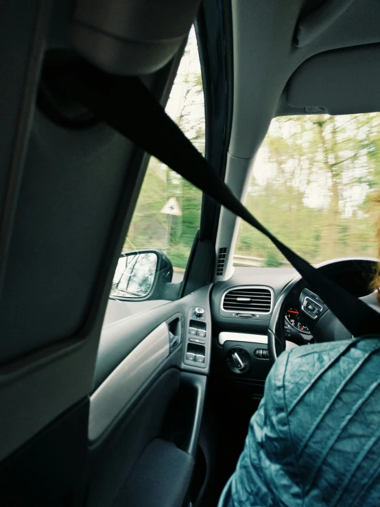 a woman sitting in the passenger seat of a car, by Cornelisz Hendriksz Vroom, unsplash, happening, square, pov from rear, low quality photo, profile image