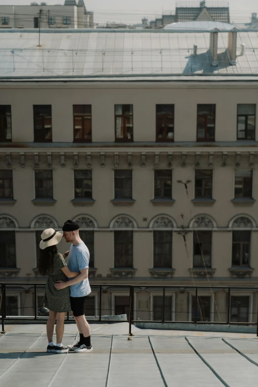 a man and a woman standing on top of a building, khreschatyk, zoomed out shot, fan favorite, kissing