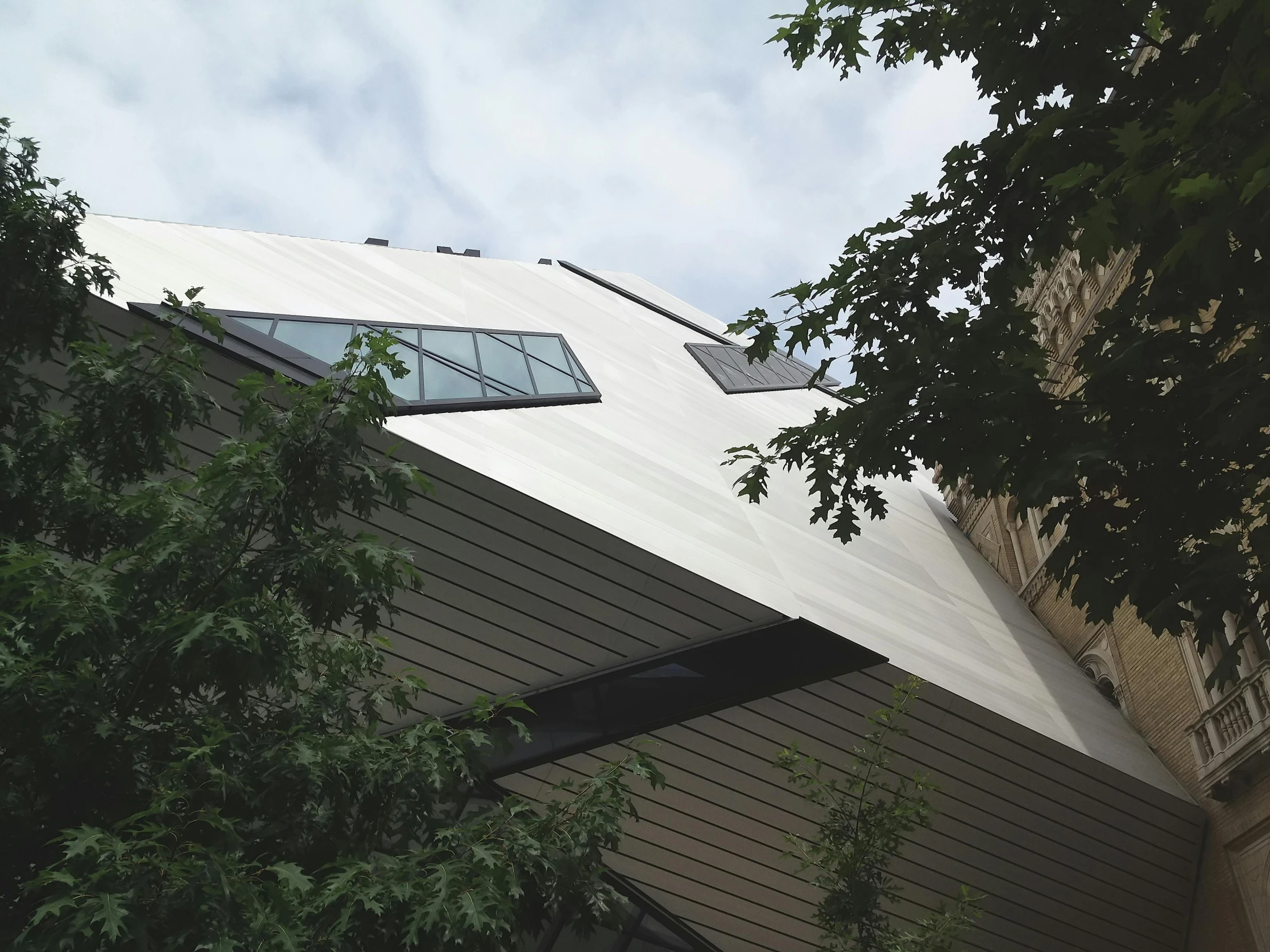 a close up of a building with a sky background, inspired by Zaha Hadid, roofed forest, metmuseum, view from the streets, over-the-shoulder shot