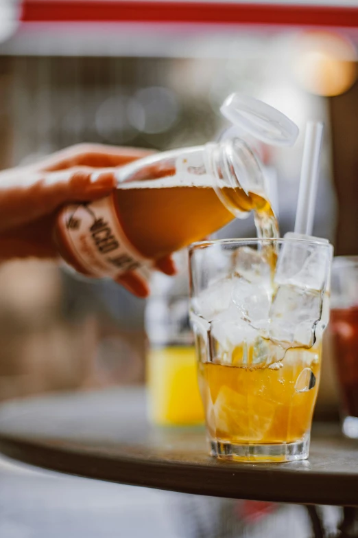 a person pouring a drink into a glass, tall iced tea glass, aussie baristas, highly upvoted, made of honey