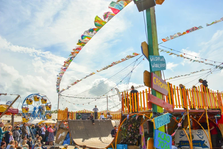 a crowd of people standing around a wooden structure, by Anna Findlay, unsplash, temporary art, colorful striped pavillions, scrapyard, baba yaga, banners