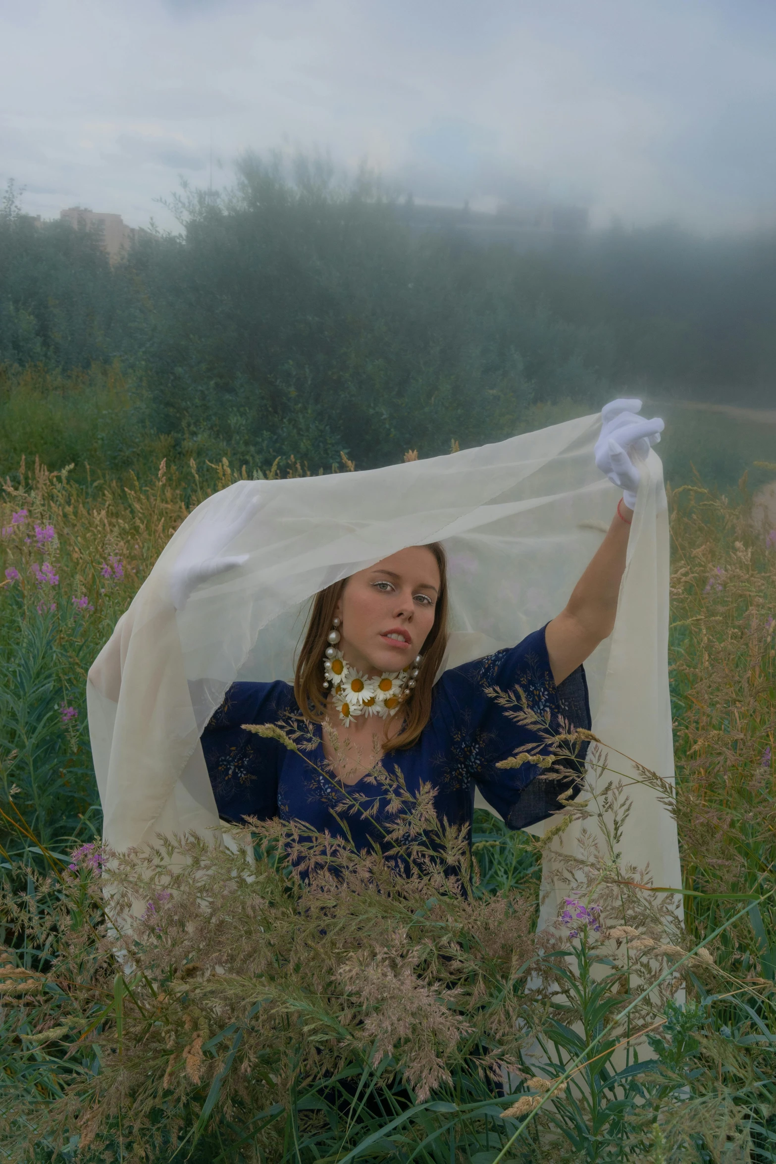 a woman sitting in a field with a veil over her head, an album cover, by Attila Meszlenyi, unsplash, renaissance, gloves and jewelry. motion, in garden, video still, porcelain