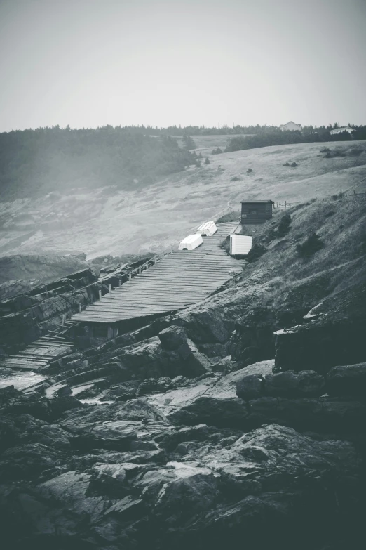 a black and white photo of a body of water, mining outpost, unsplash photography, wooden houses, album cover