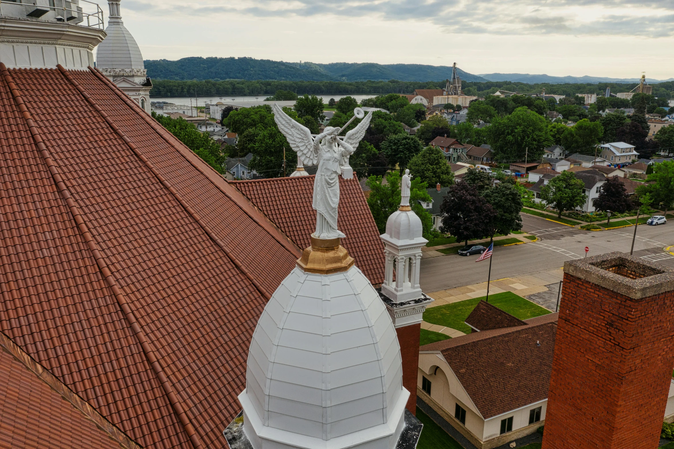 a clock tower with a statue on top of it, a statue, by Robert Storm Petersen, drone wide shot, churches, fan favorite, as seen from the canopy