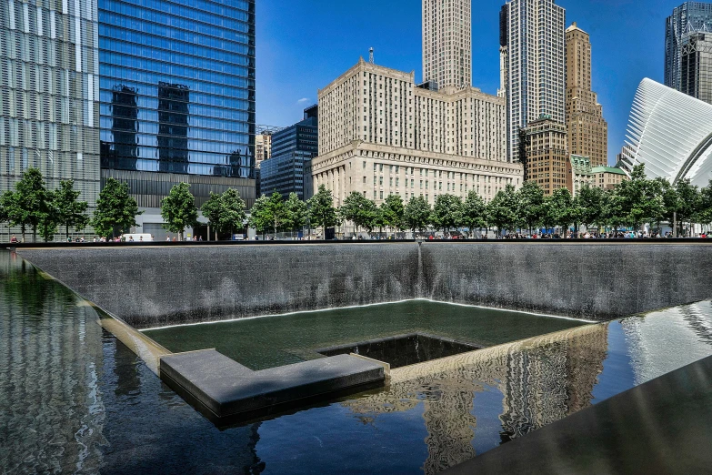 a fountain in the middle of a city with skyscrapers in the background, inspired by René Burri, unsplash contest winner, reflecting pool, 2022 photograph, sunken square, americana architecture