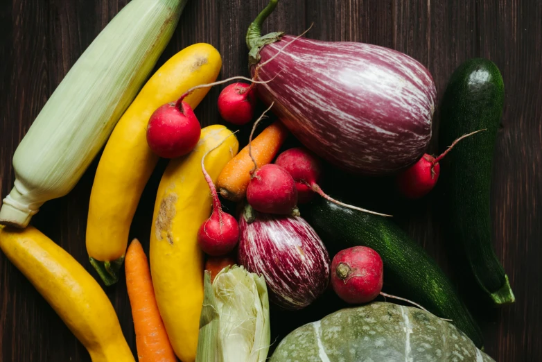 a bunch of vegetables sitting on top of a wooden table, unsplash, renaissance, background image, multicoloured, close body shot, uncrop