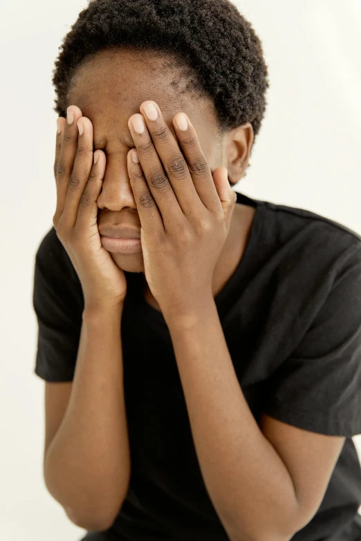 a woman covers her eyes with her hands, by Everett Warner, pexels, black teenage boy, bruised face, set against a white background, giga chad crying