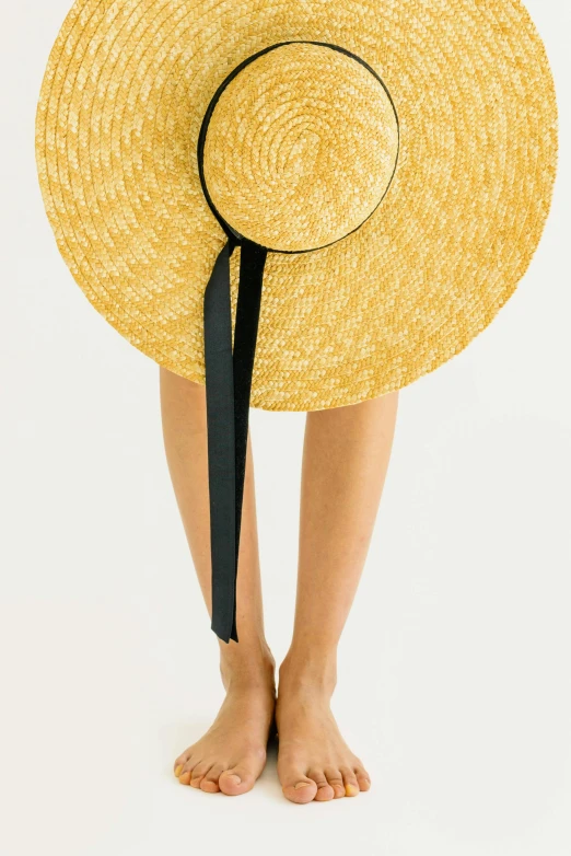 a woman wearing a straw hat with a black ribbon, trending on unsplash, conceptual art, sleek legs, yellow carpeted, transparent background, multiple stories