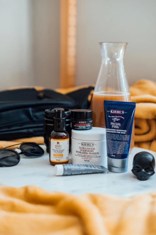 an assortment of skin care products sitting on a bed, a still life, featured on reddit, bags under his eyes, badass look, detailed product image, black