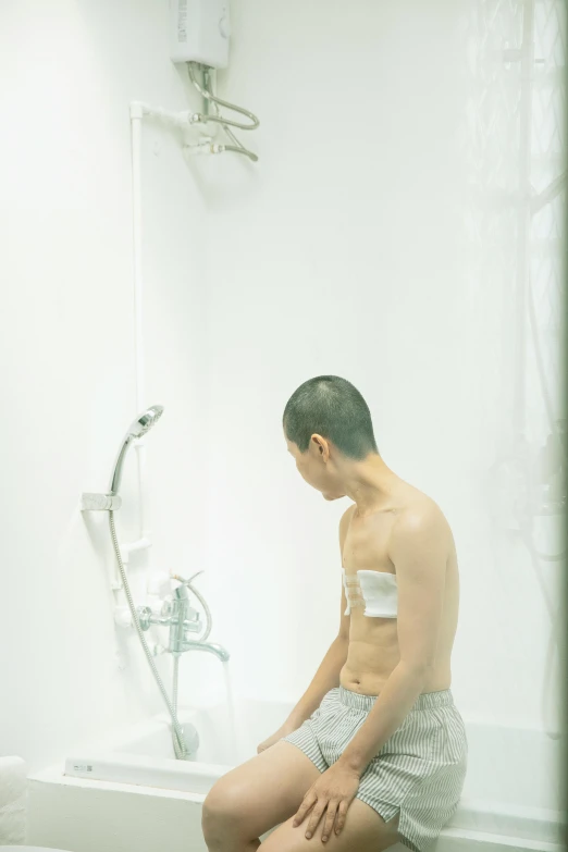 a man sitting on a toilet in a bathroom, an album cover, inspired by Zhang Kechun, unsplash, gutai group, translucent body, teenage boy, under a shower, 王琛