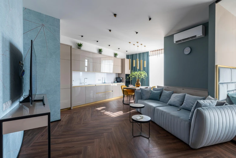 a living room filled with furniture and a flat screen tv, by Adam Marczyński, pexels contest winner, light and space, cyan and gold scheme, herringbone floor, minimal kitchen, high ceiling