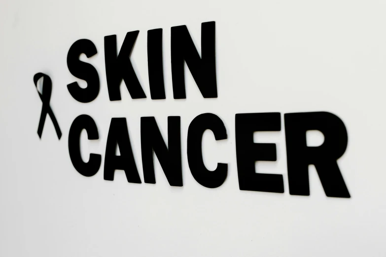 a black and white sign that says skin cancer, by Gavin Hamilton, 15081959 21121991 01012000 4k, detail shot, with a white background, silicone skin