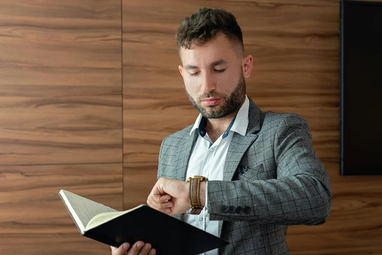 a man in a suit is reading a book, trending on pexels, renaissance, wearing a watch, professional modeling, hasbulla magomedov, wearing a shirt