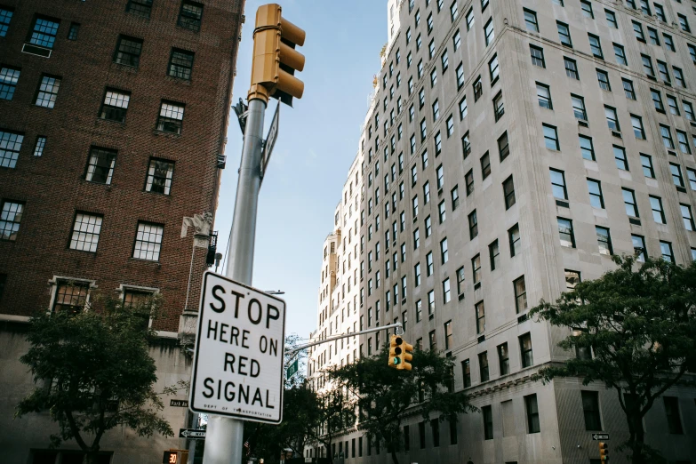 a street sign that reads stop here in red signal, pexels, new york buildings, very high resolution, instagram post, 2 0 0 0's photo