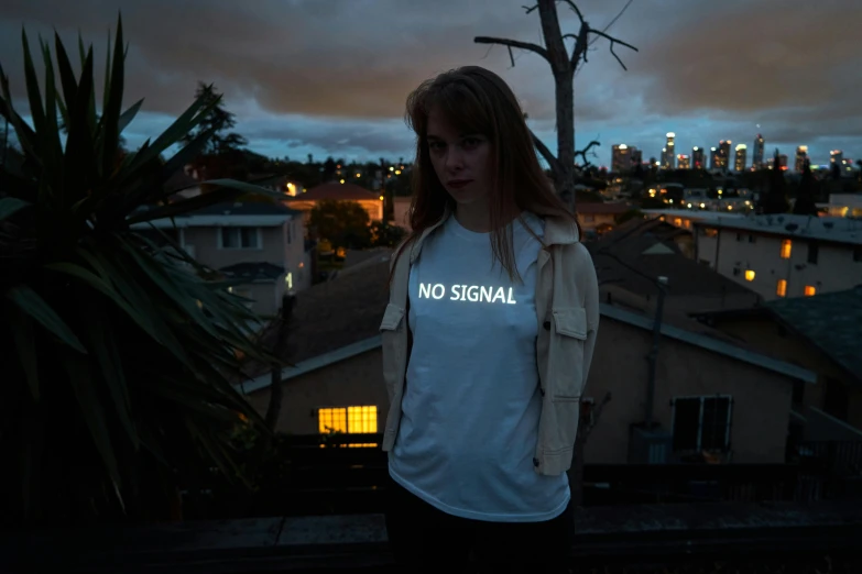 a woman standing on top of a roof next to a tree, inspired by Elsa Bleda, graffiti, electrical signals, federation clothing, woman holding sign, nocturnal