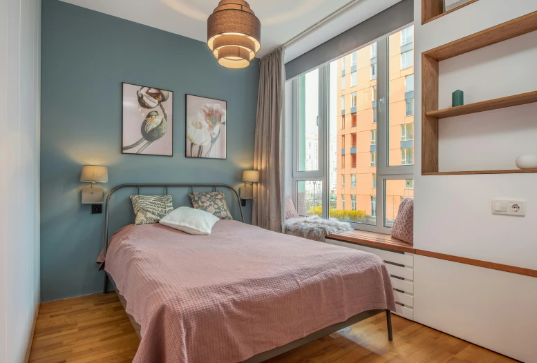 a bed sitting in a bedroom next to a window, by Adam Marczyński, unsplash contest winner, maximalism, teal and pink, city apartment cozy calm, floor - to - ceiling windows, small and cosy student bedroom