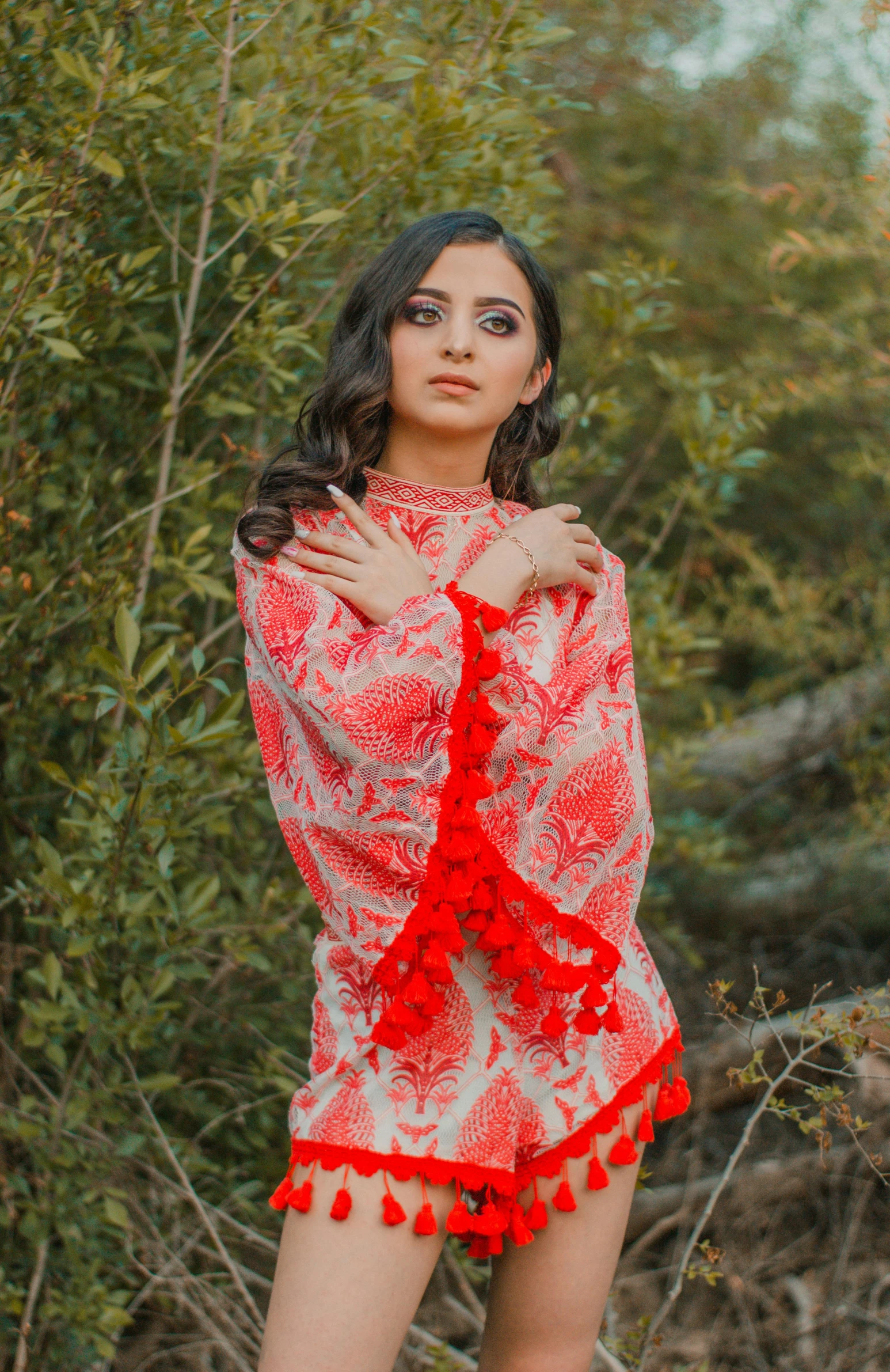 a woman in a red dress posing for a picture, inspired by Lubna Agha, pexels, arabesque, tunic, beautiful young himalayan woman, delicate patterned, foliage clothing