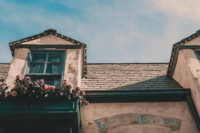 a close up of a building with a sky background, pexels contest winner, arts and crafts movement, a multidimensional cozy tavern, vintage aesthetic, flowery cottage, unsplash photography