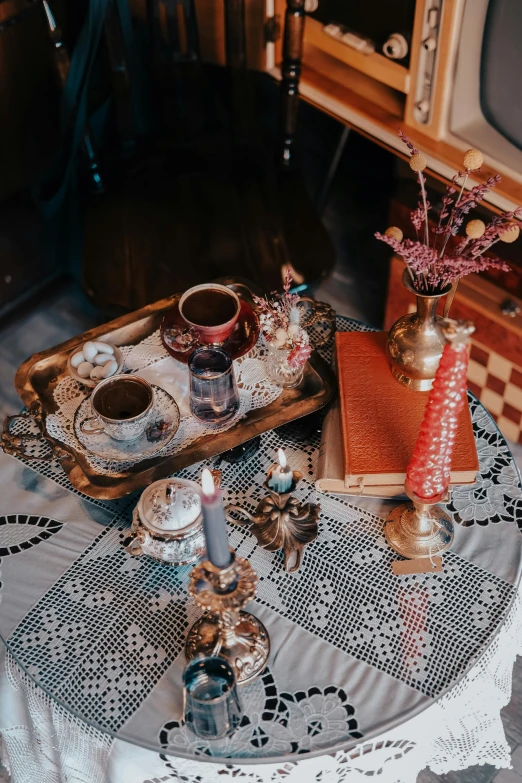 a tv sitting on top of a wooden table, moroccan tea set, steampunk aesthetic, - 8