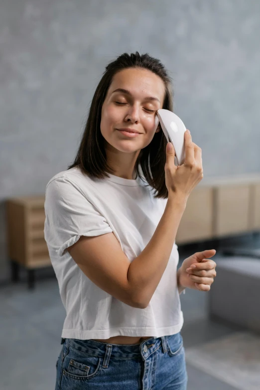 a woman wiping her face with a towel, by Adam Marczyński, pexels contest winner, with electric arc device, wearing a light shirt, smooth oval shape face, turning her head and smiling