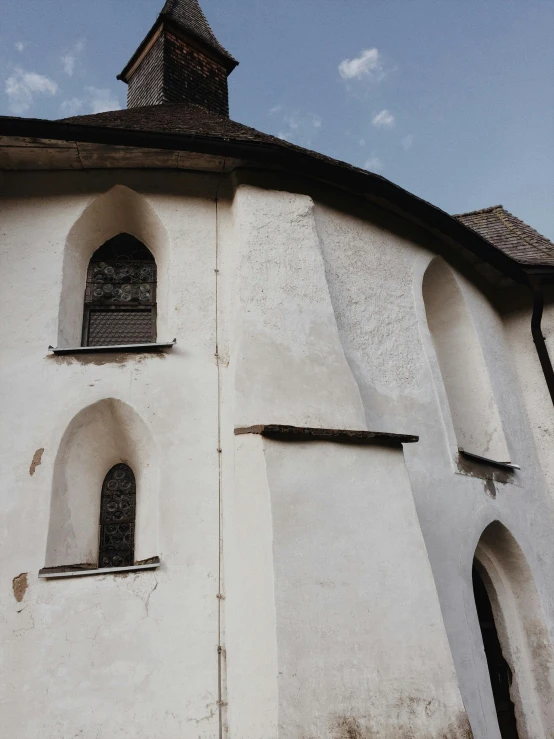 a large white building with a clock on top of it, an album cover, inspired by Károly Markó the Elder, pexels contest winner, romanesque, thatched roof, windows and walls :5, panorama view, religious